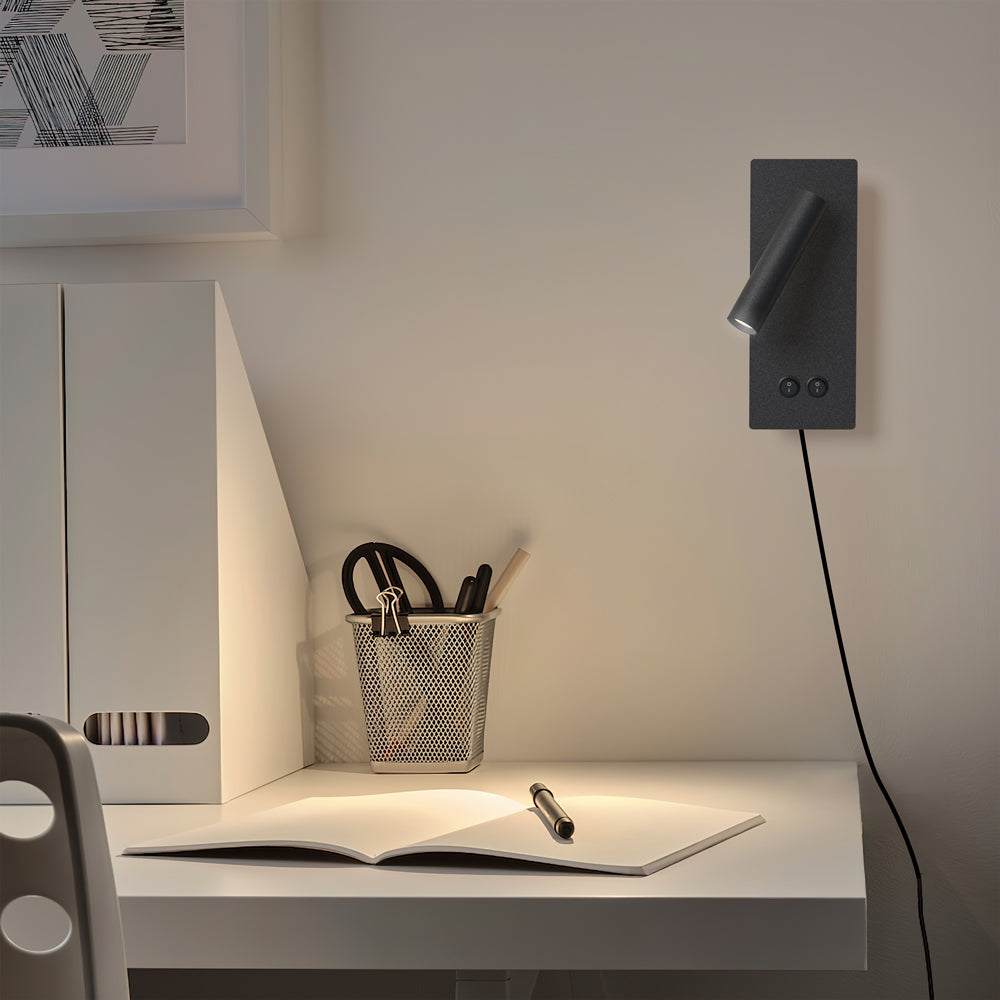 Plug-in reading wall light casting a focused pool of light