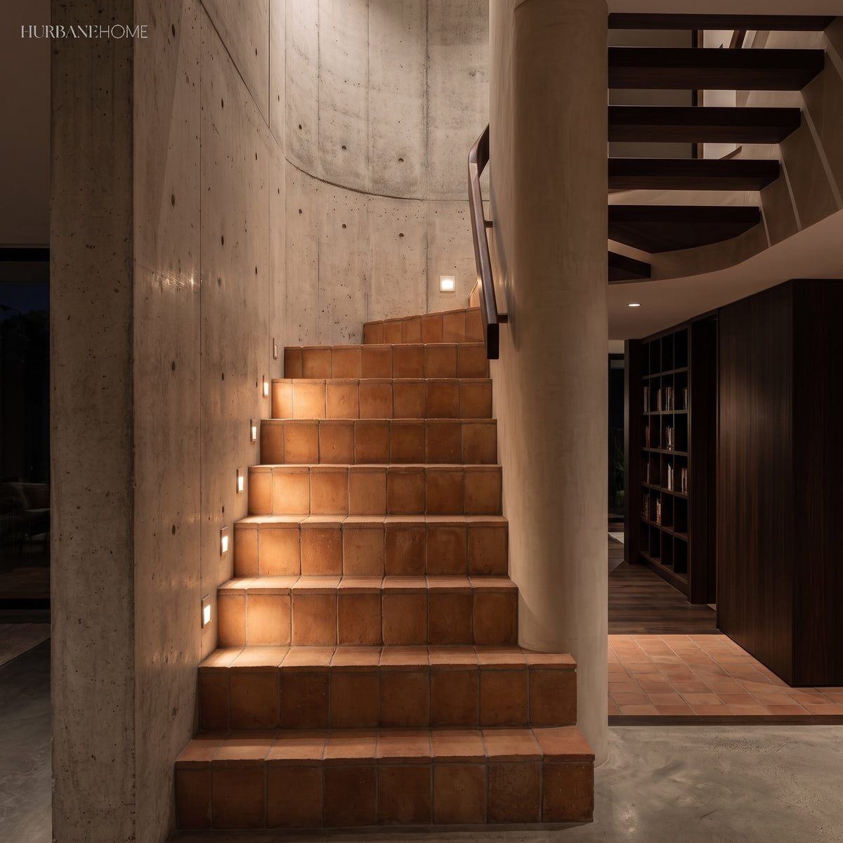 Recessed step lights along a concrete stairwell lighting warm timber treads