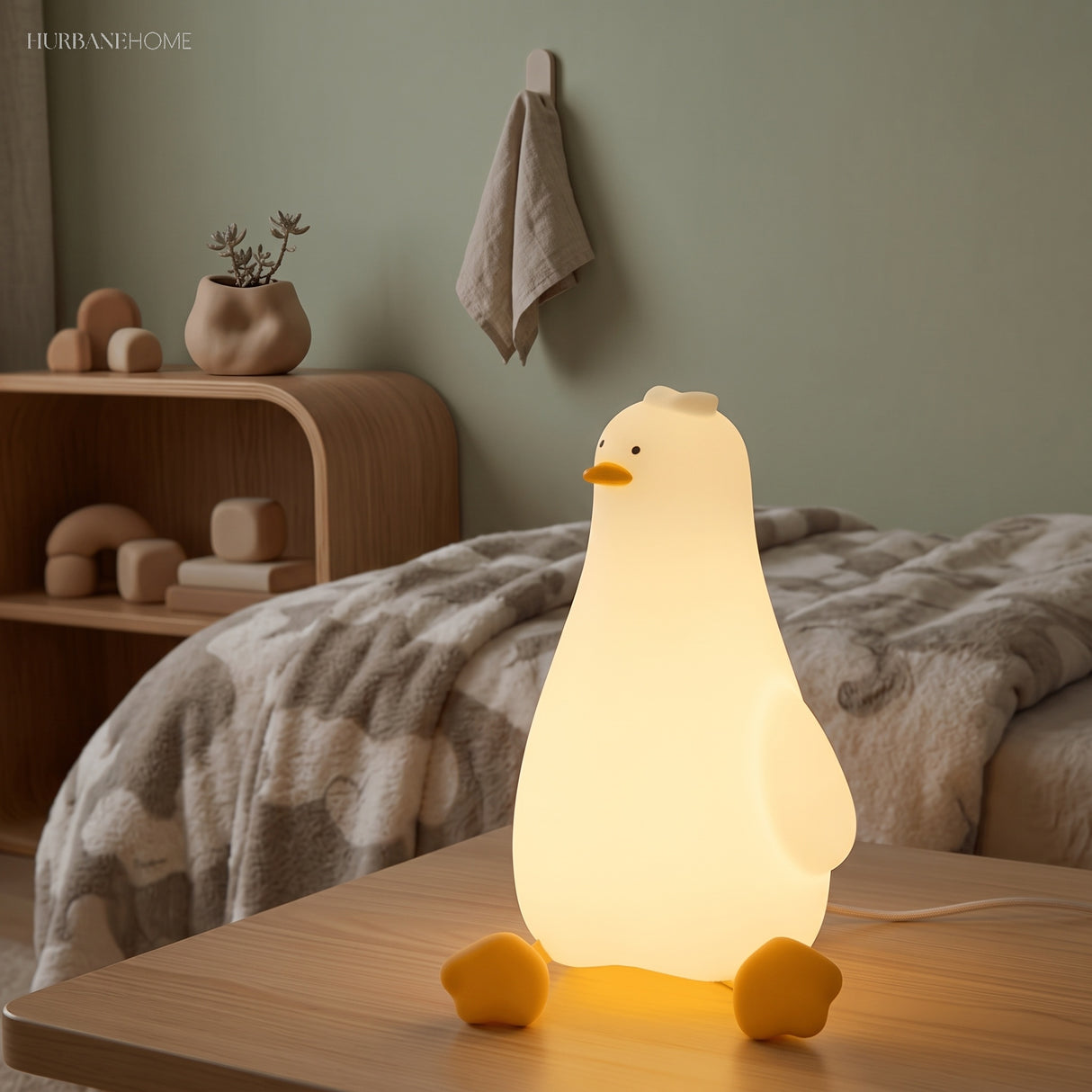 Rechargeable goose night light lighting a calm toddler bedroom beside a cosy bed