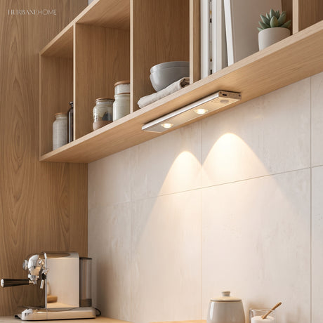 Slim light bar under an oak shelf casting two warm pools on tiles