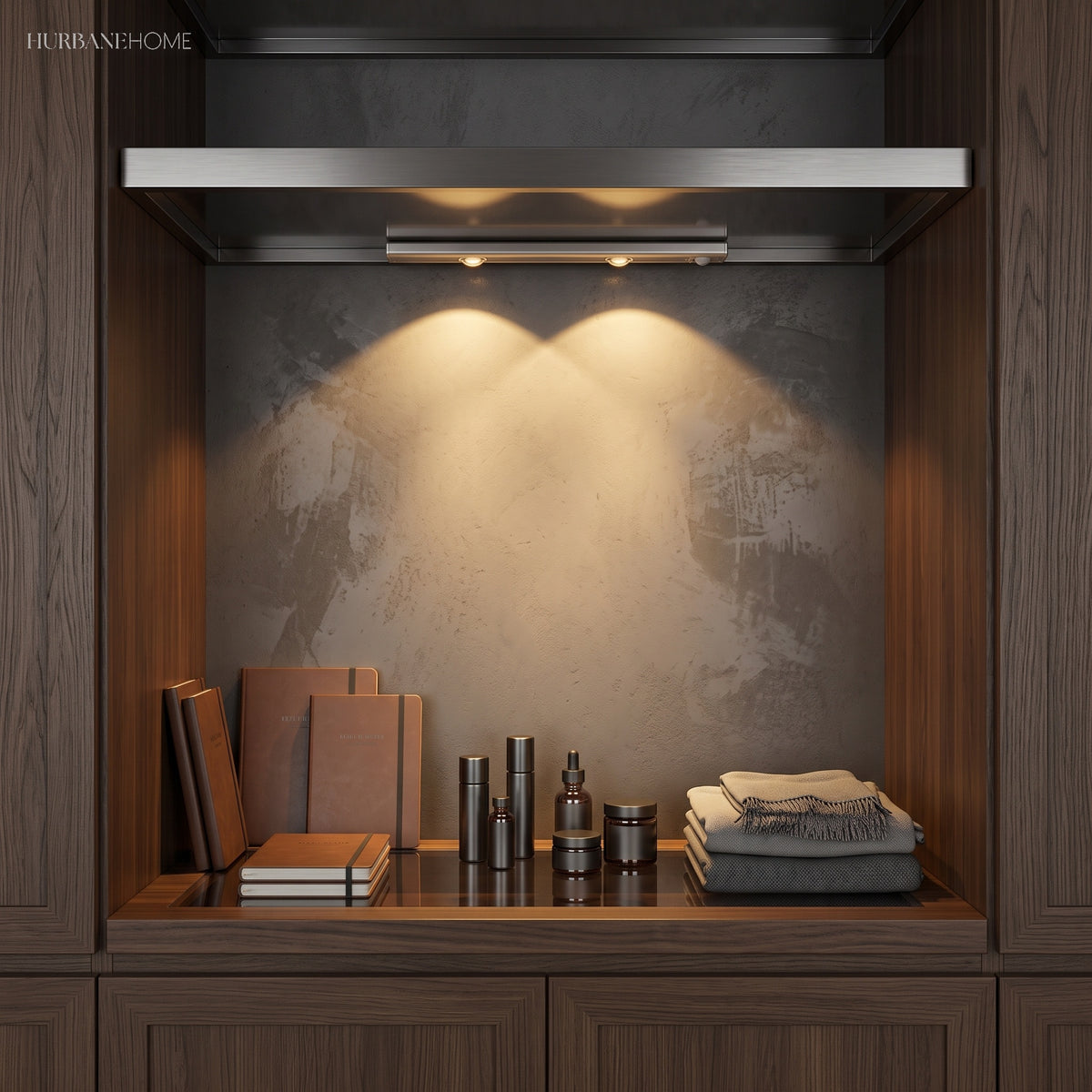 Under cabinet bar lighting a dark stone alcove above books and folded linen