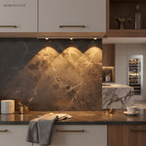 Under cabinet light grazing a dark marble splashback in a modern kitchen