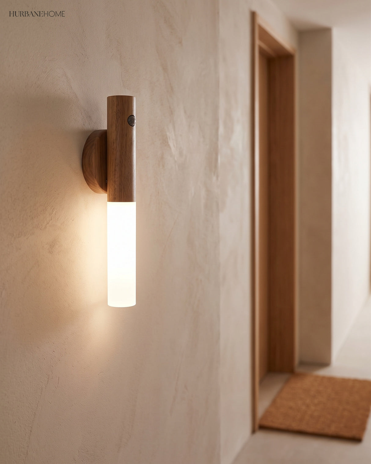 Slim wall light glowing along a pale plaster hallway at night