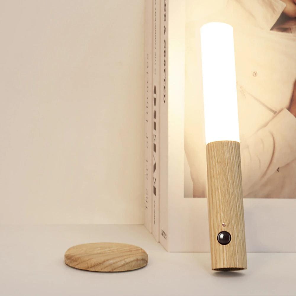 Lamp leaning against a shelf beside its round wooden wall mount