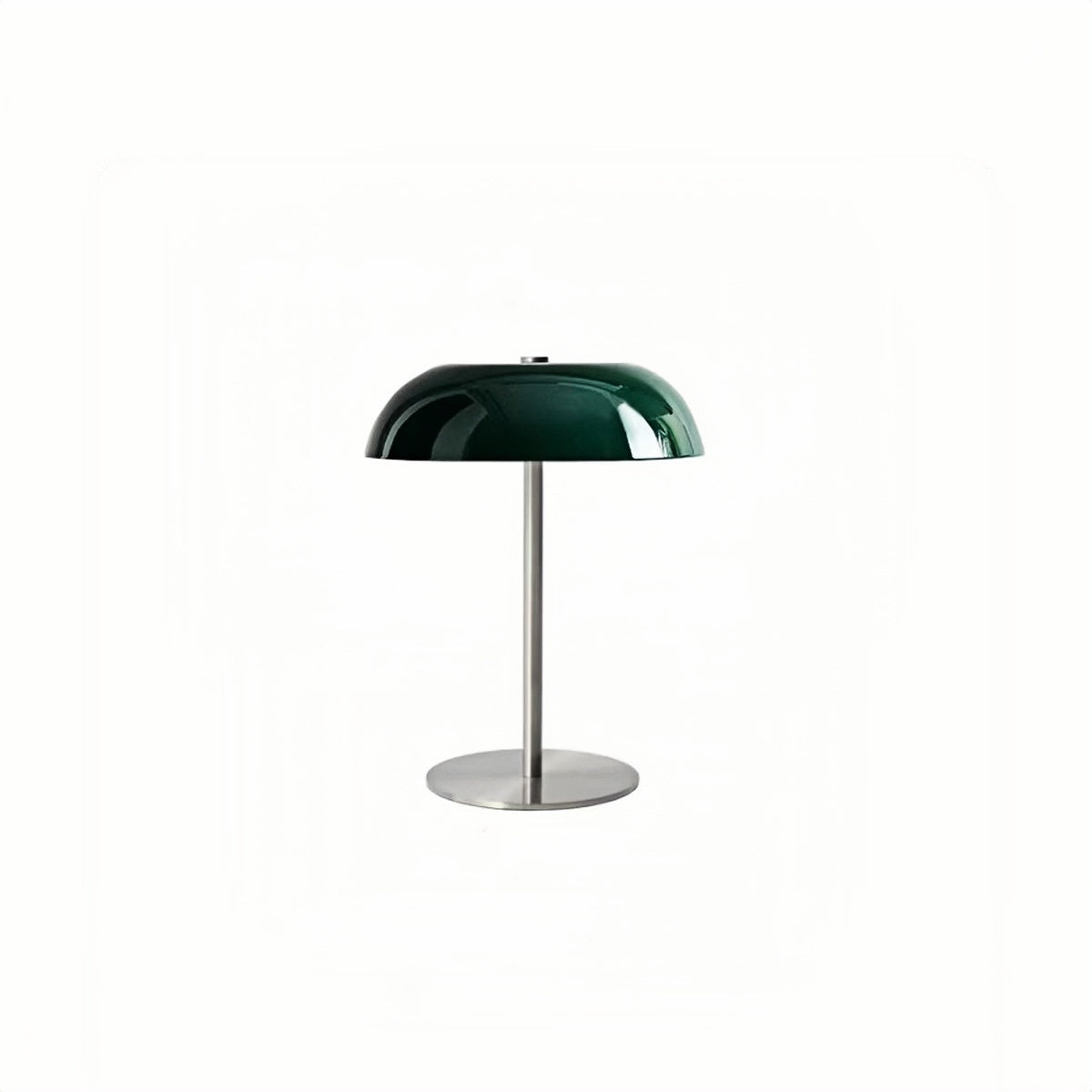 Green dome table lamp with a slim stem and round base on white