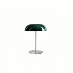 Green dome table lamp with a slim stem and round base on white