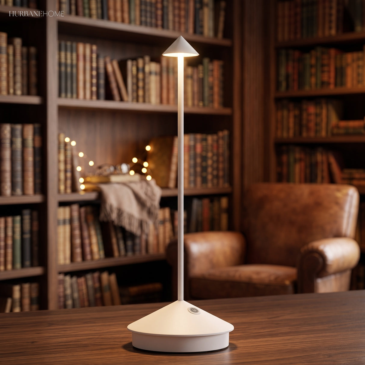 White rechargeable table lamp lit on a wooden shelf-lined reading nook table