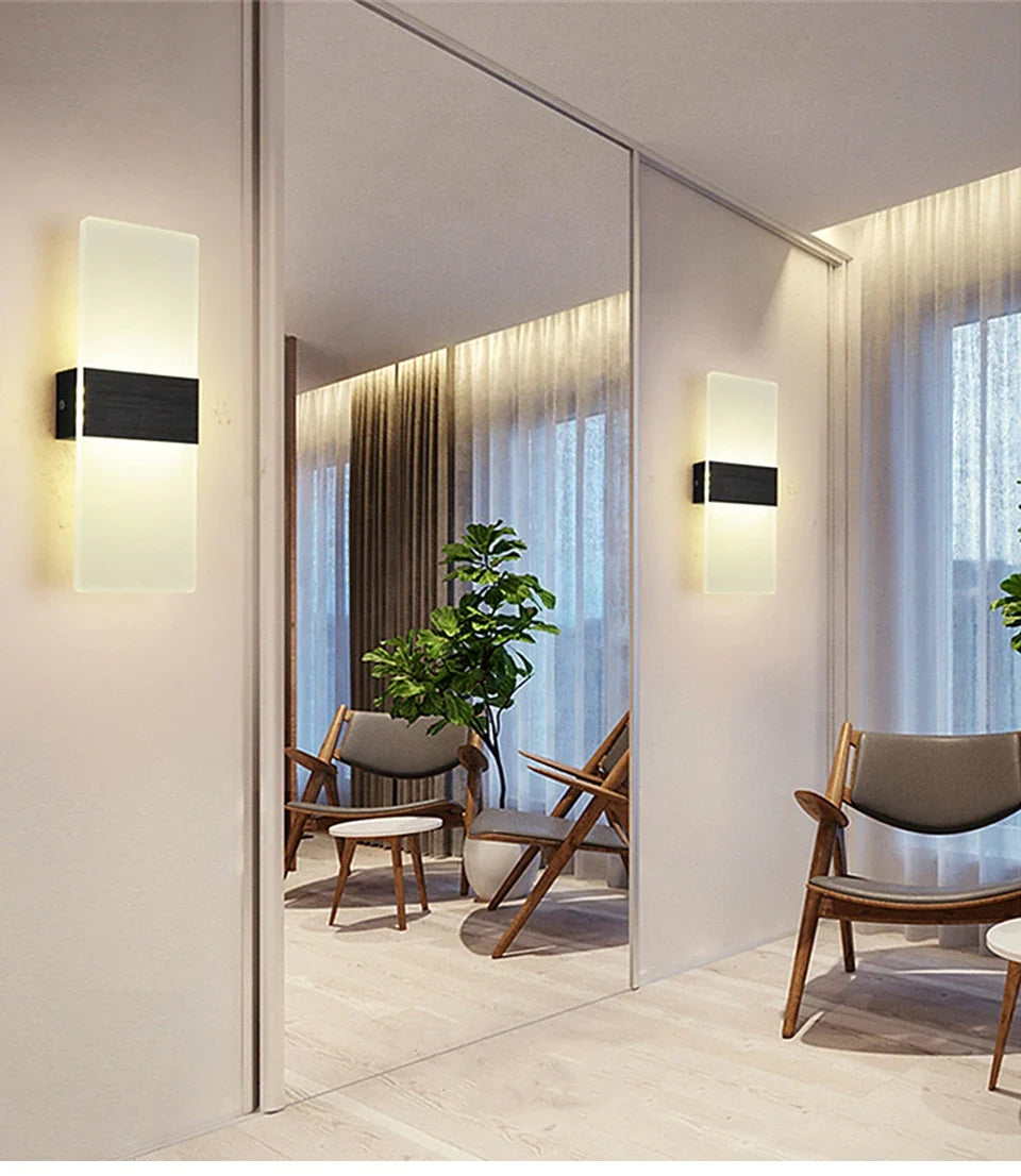 Two acrylic panel wall lights reflected in a mirrored wall