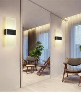 Two acrylic panel wall lights reflected in a mirrored wall
