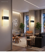 Two acrylic panel wall lights lit on a wall in a living room