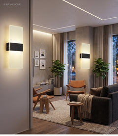 Two acrylic panel wall lights lit on a wall in a living room