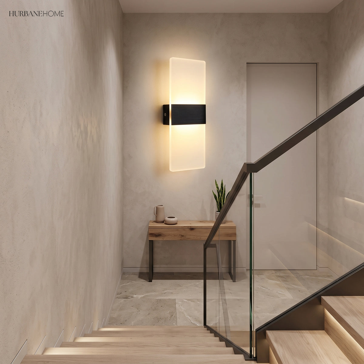 Black acrylic panel wall light lit beside a staircase
