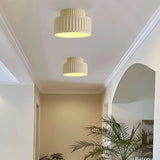 Red fluted semi flush mount ceiling light on a plain studio background