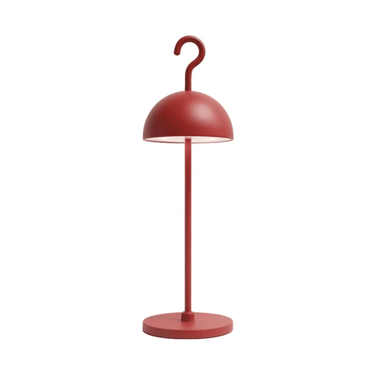 Deep red metal dome table lamp lit from within on a round weighted base