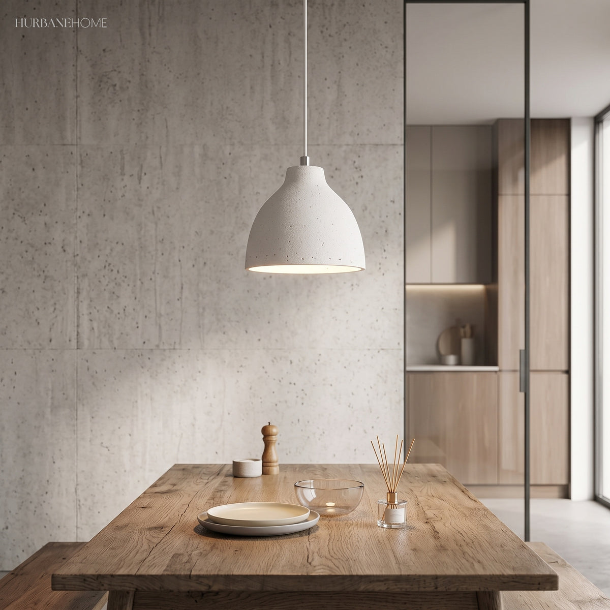 White dome pendant lighting a timber dining table beside concrete wall