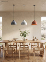 Grey, white and terracotta dome pendants over a pale timber table