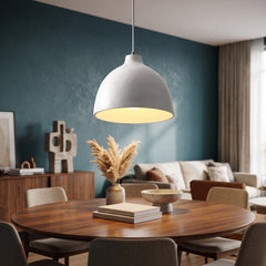 White speckled resin dome pendant above a round walnut dining table