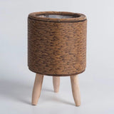 Resin wicker plant stand supporting woven indoor planter