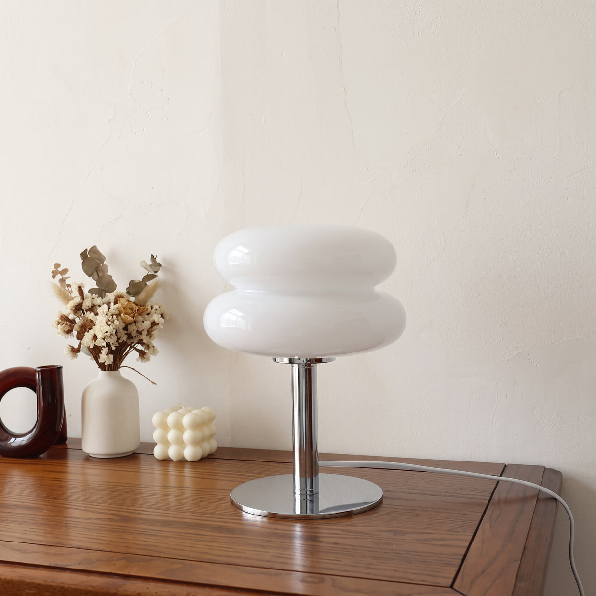 Retro double glass table lamp in white on a timber sideboard