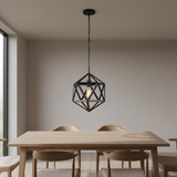 A black geometric wireframe pendant light hangs above a light wood dining table with four chairs in a minimalist dining room.