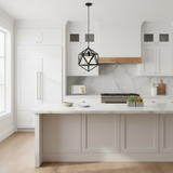 A modern kitchen interior with white shaker-style cabinets, a white marble backsplash, a light wood range hood trim, and a black geometric pendant light hanging above the island.
