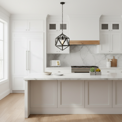 A modern kitchen interior with white shaker-style cabinets, a white marble backsplash, a light wood range hood trim, and a black geometric pendant light hanging above the island.