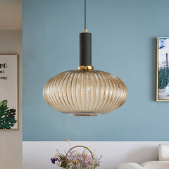 Amber ribbed oval pendant lit on a blue wall above a basket