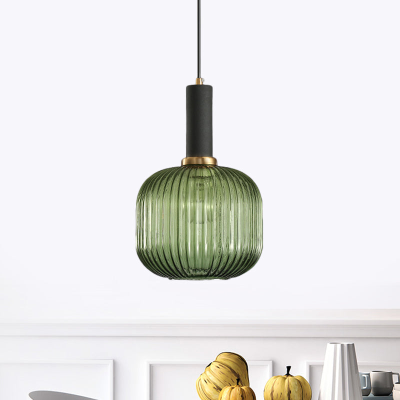 Green ribbed capsule pendant lit above a kitchen bench of fruit