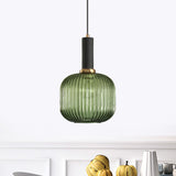 Green ribbed capsule pendant lit above a kitchen bench of fruit