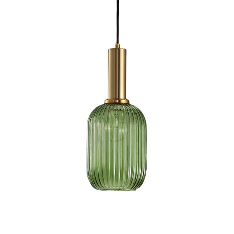 Green ribbed capsule pendant with a brass collar, shown lit