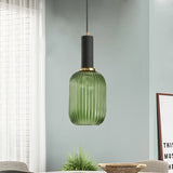 Green ribbed pendant lit by a window on a pale green wall
