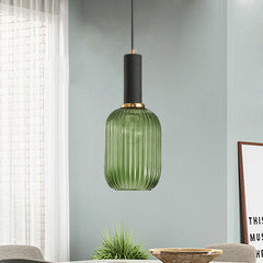 Green ribbed pendant lit by a window on a pale green wall