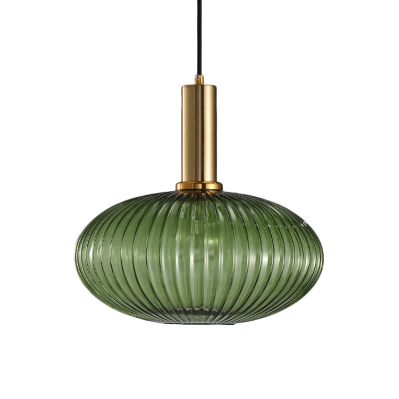 Green ribbed oval pendant with a brass collar, shown on white