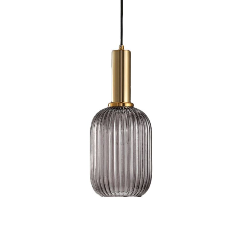 Smoke ribbed capsule pendant with a brass collar on white