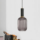 Smoke ribbed pendant lit against a plain white painted wall