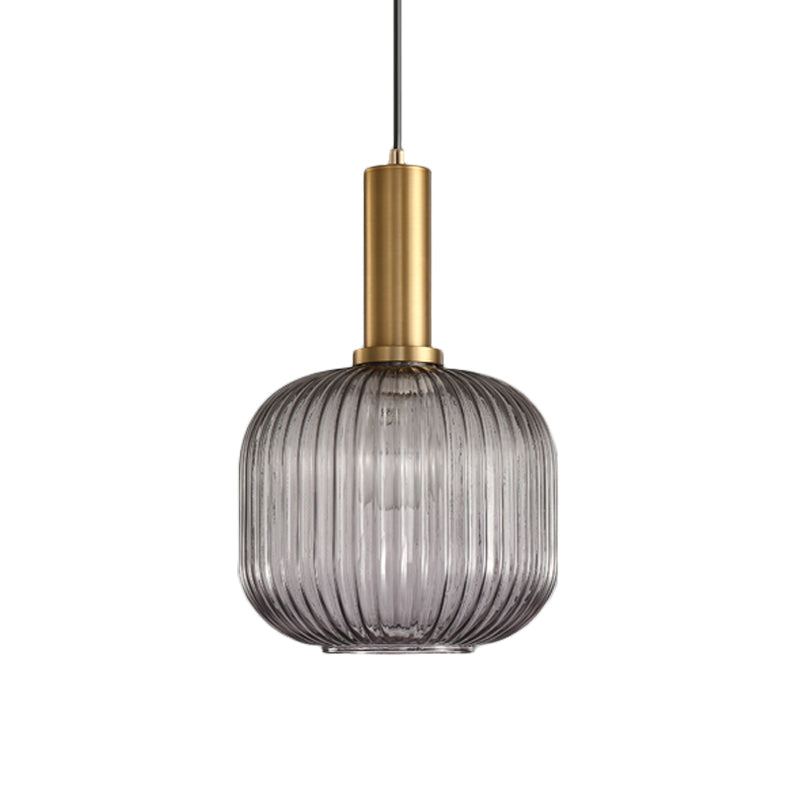 Smoke ribbed cylinder pendant with a brass collar on white