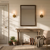 Pair of tube sconces either side of a mirror above a farmhouse console