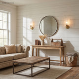 Ribbed glass sconces flanking a round mirror in a shiplap living room
