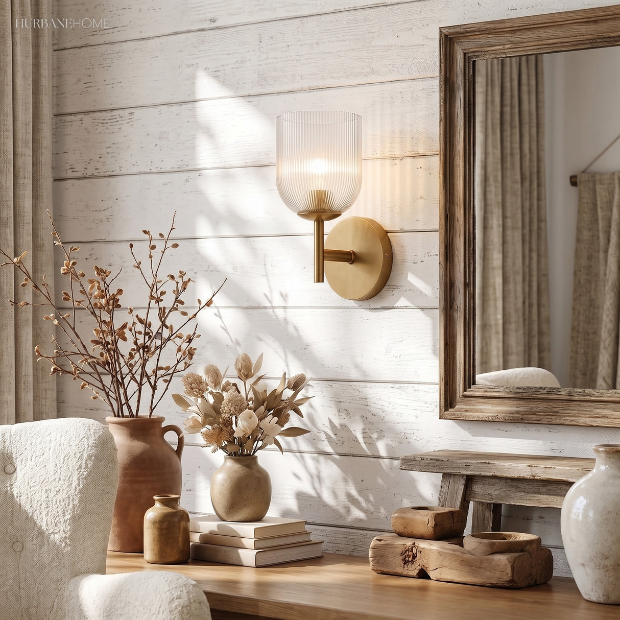 Three ribbed glass sconces on a reclaimed timber wall above a console