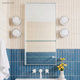 Four ribbed wall lights flanking a bathroom mirror above blue tiles