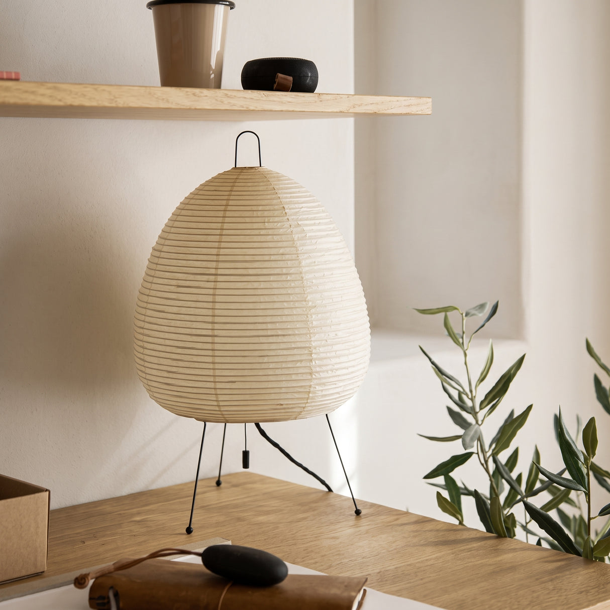 Rice paper table lamp with teardrop shade on a timber surface