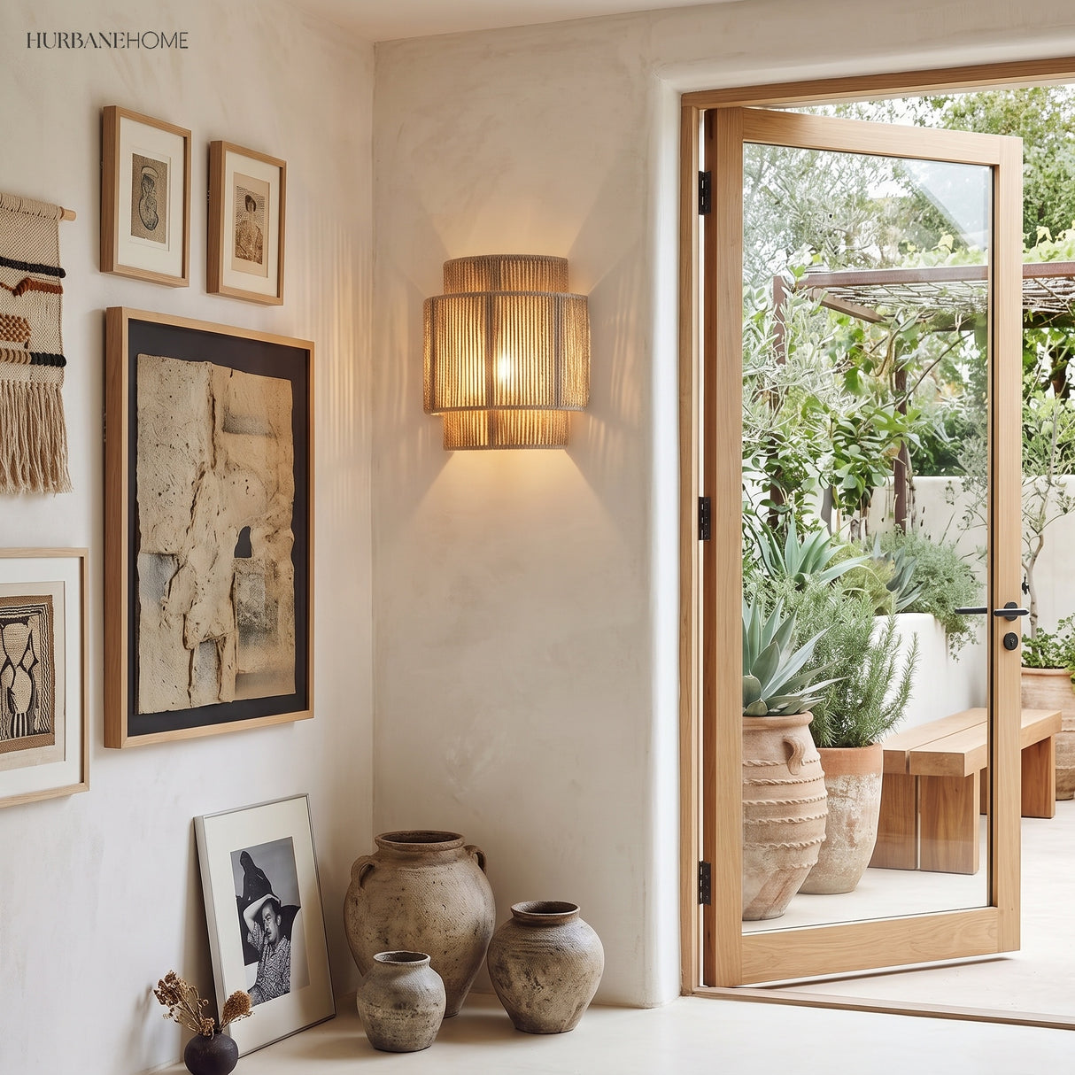 Rope wall lamp beside a gallery wall and open garden door