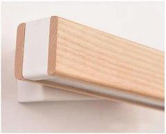 Close view of the oak bar and its white curved mounting bracket