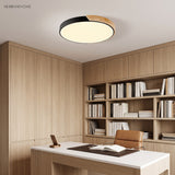 Black round LED ceiling light with wood rim in a timber lined home office