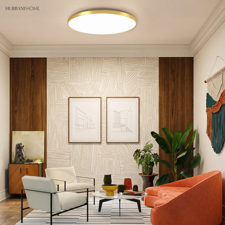 Round LED ceiling light above a living room with armchairs and plants