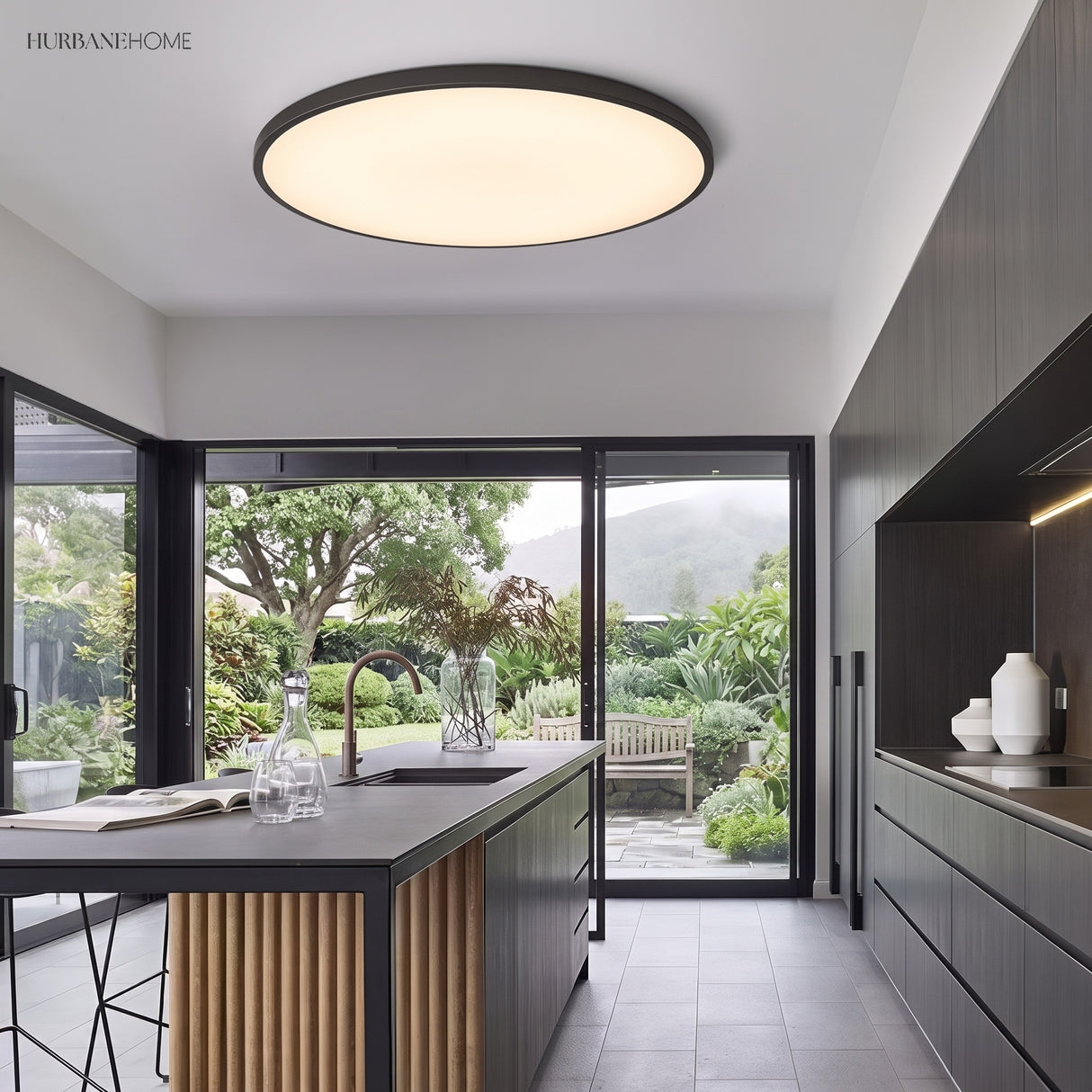 Round LED ceiling light in a kitchen with island and garden view