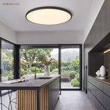 Round LED ceiling light in a kitchen with island and garden view