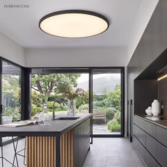 Round LED ceiling light in a kitchen with island and garden view