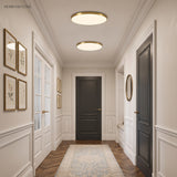 Two round LED ceiling lights along a panelled hallway