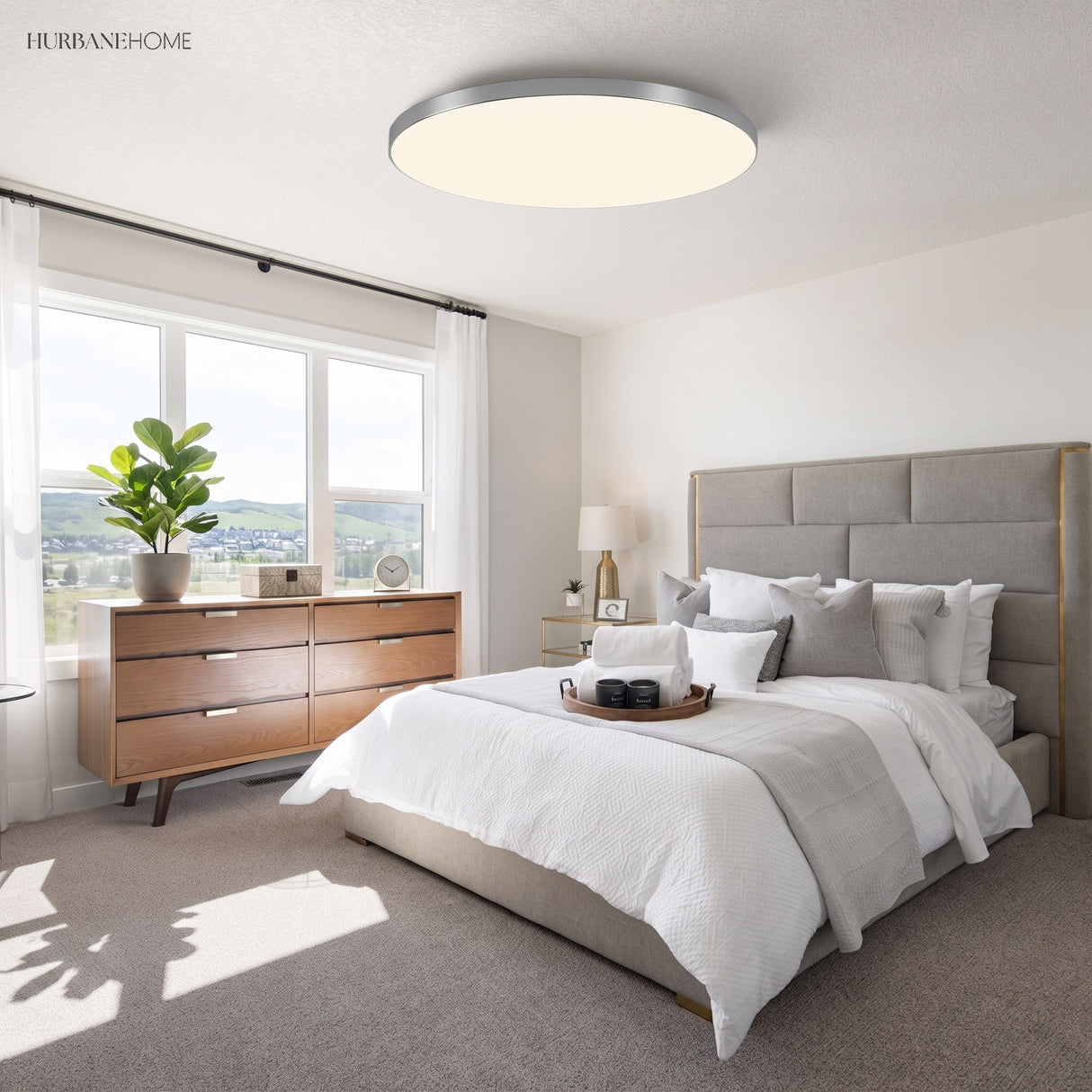 Round LED ceiling light in a bright bedroom with timber dresser